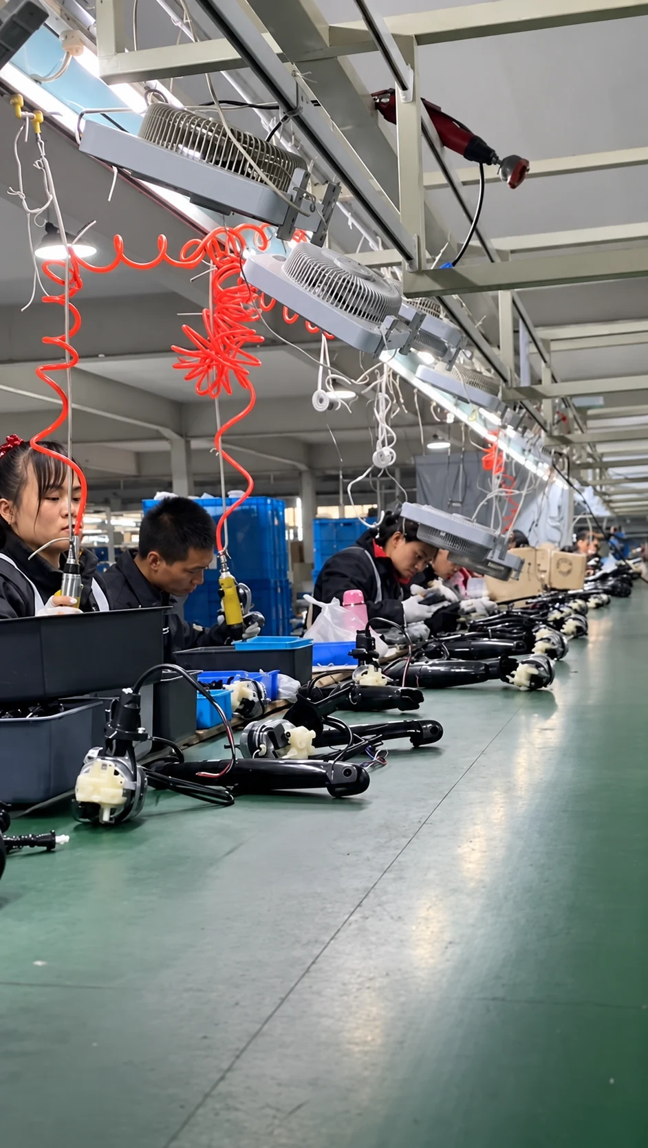 Workers assembling appliances on the production line